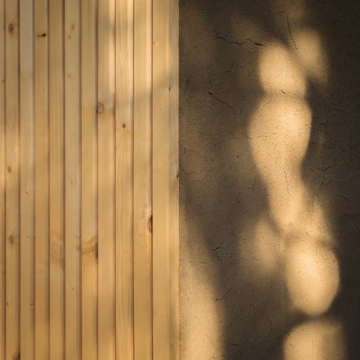 wooden facade with clay plaster