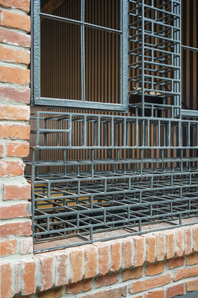 Detail of original recovered window frames and detail of art installation that show the original window holes